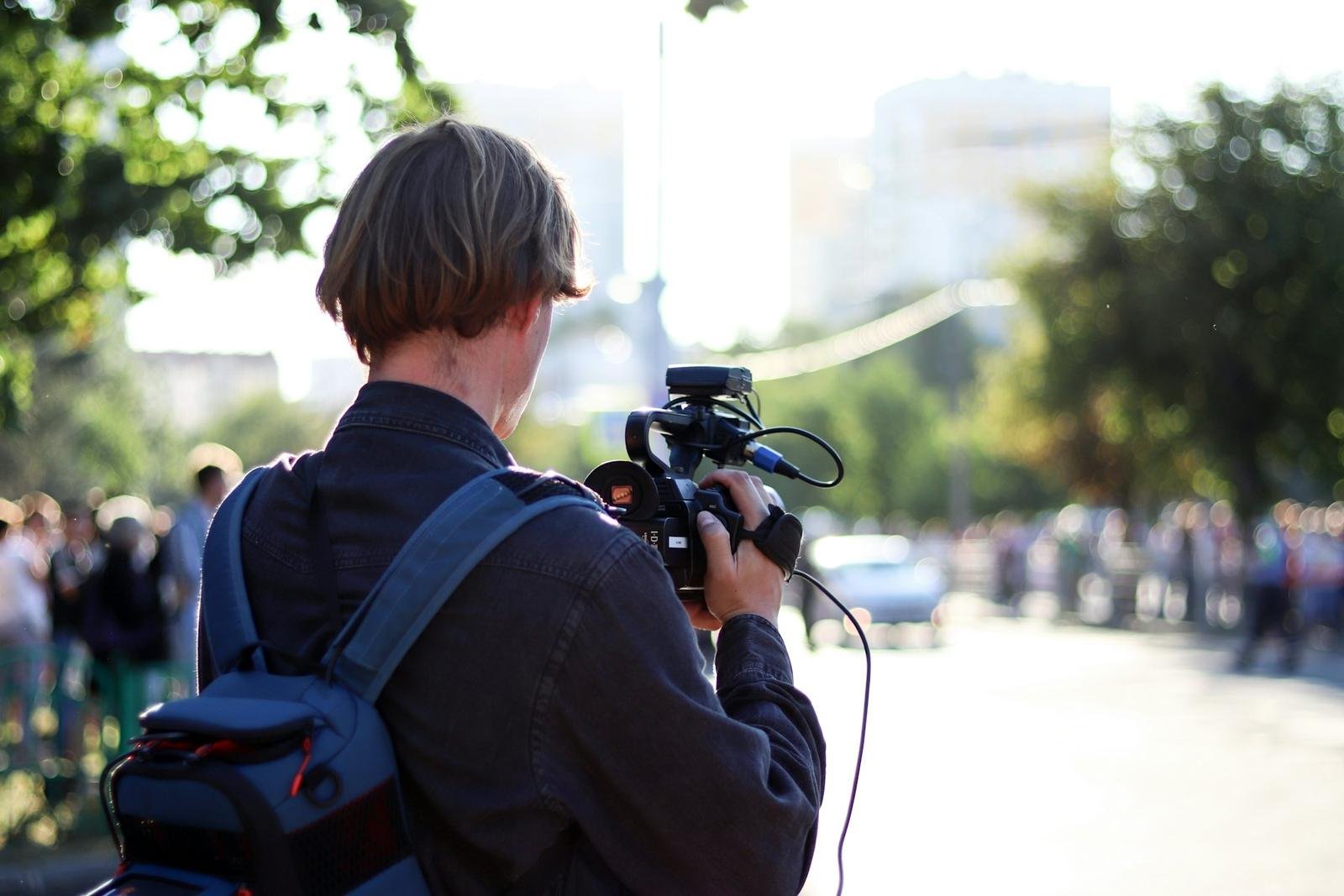 A photographer with a camera at a street demonstration