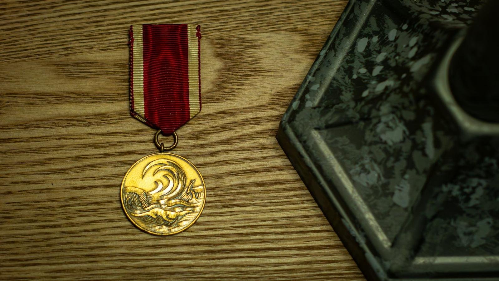 A gold medal on a red ribbon